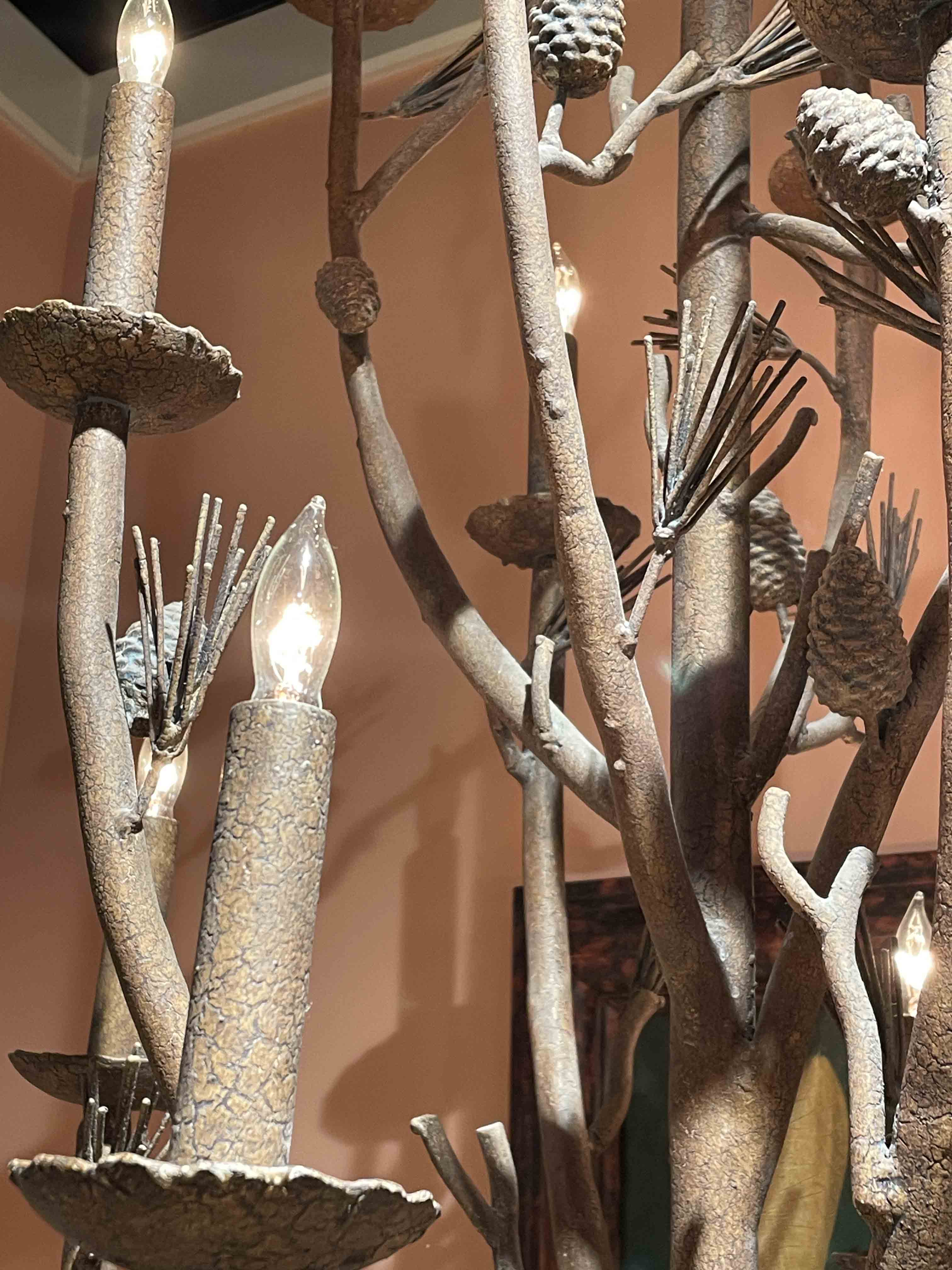 Metal chandelier formed pine branches w/ pine cones